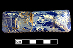 Pearlware knife rest printed underglaze in medium blue in floral pattern. Dimensions: 3.75” x 1.75.”